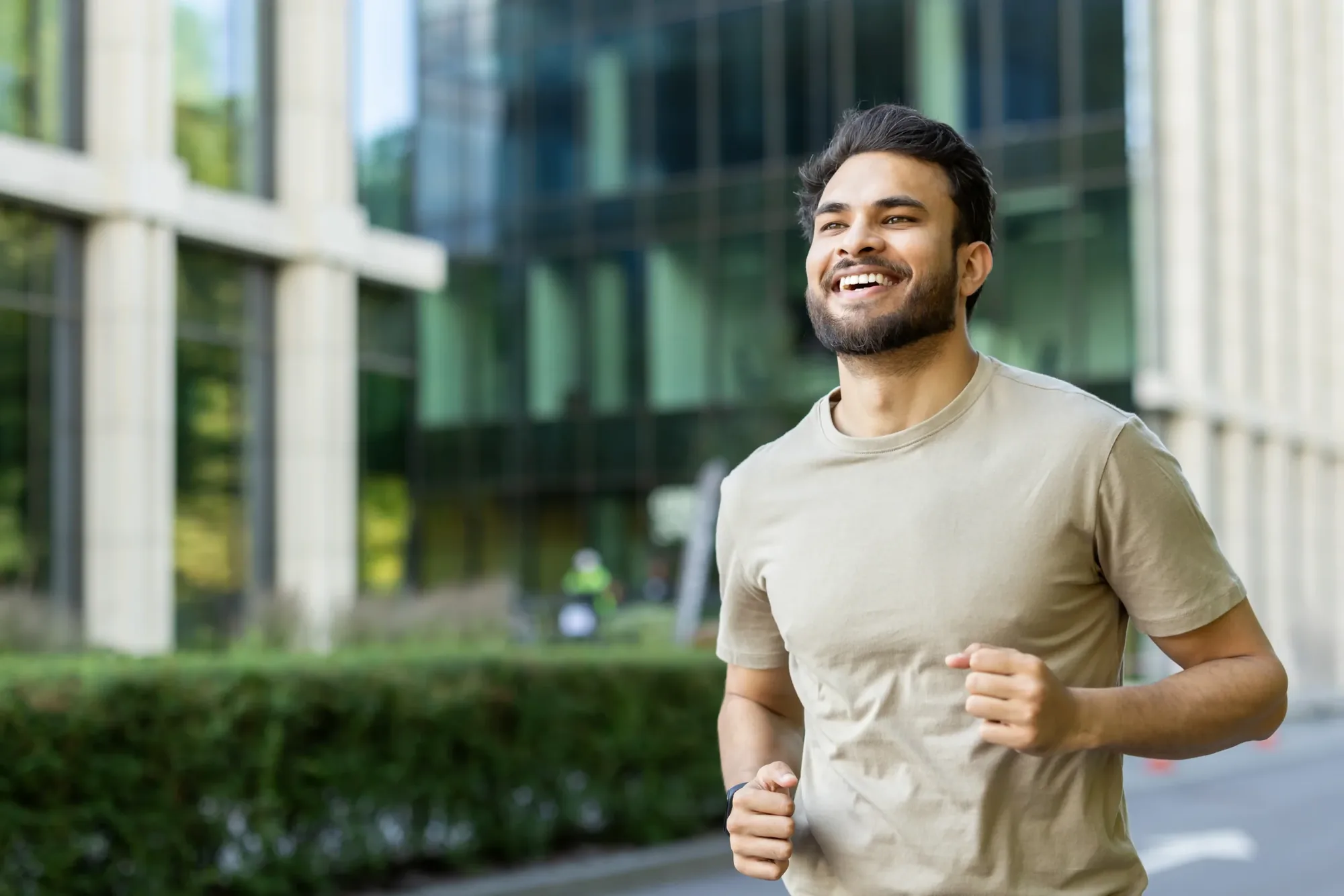 Man walking outdoors in a city, dressed for exercise